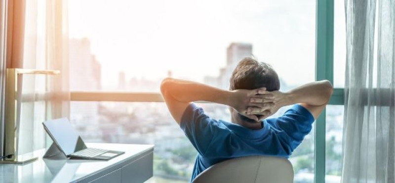 A man resting while looking at his window